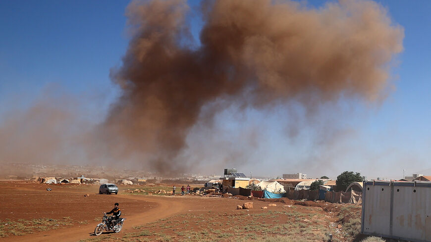 Smoke billows following Russian airstrikes near Syria's Bab al-Hawa border crossing with Turkey, Sept. 27, 2022.