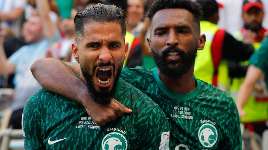 Saudi Arabia's forward #11 Saleh Al-Shehri celebrates with fellow striker #09 Firas Al-Buraikan after scoring against Argentina on Monday