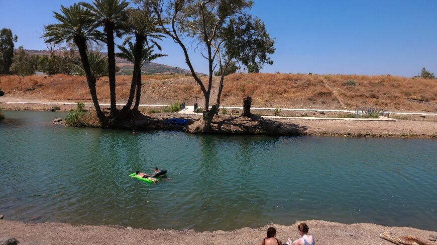 Israelis camping by the Jordan River near the Sea of Galilee, or Lake Tiberias, one of the main water sources in Israel, in this picture from July 13, 2021