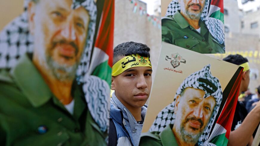 Palestinian Fatah movement supporters gather during a rally commemorating the 18th anniversary of late Palestininian leader Yasser Arafat's death in the West Bank city of Nablus on November 14, 2022.