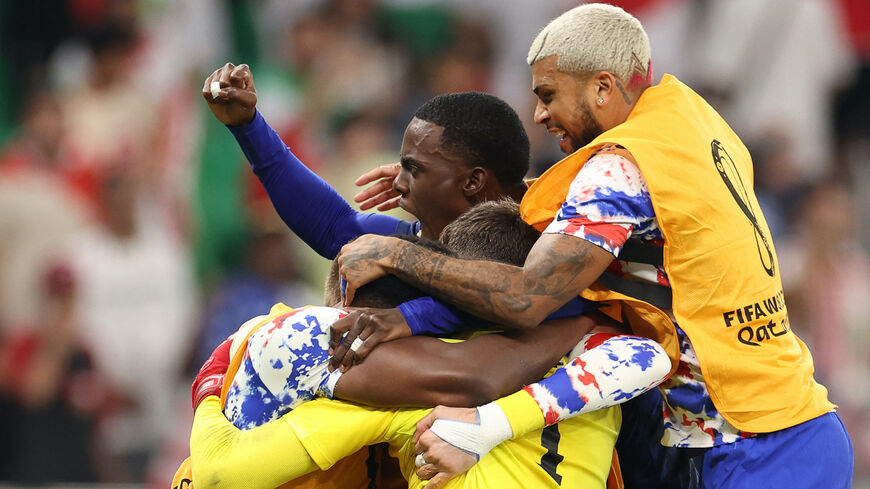 USA's teammates celebrate at the end of the Qatar 2022 World Cup Group B football match between Iran and USA at the Al-Thumama Stadium in Doha on Nov. 29, 2022.