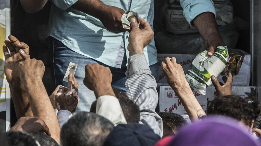 Egyptians buy sugar from a truck as the country suffers from a sugar shortage, Cairo, Egypt, Oct. 26, 2016.