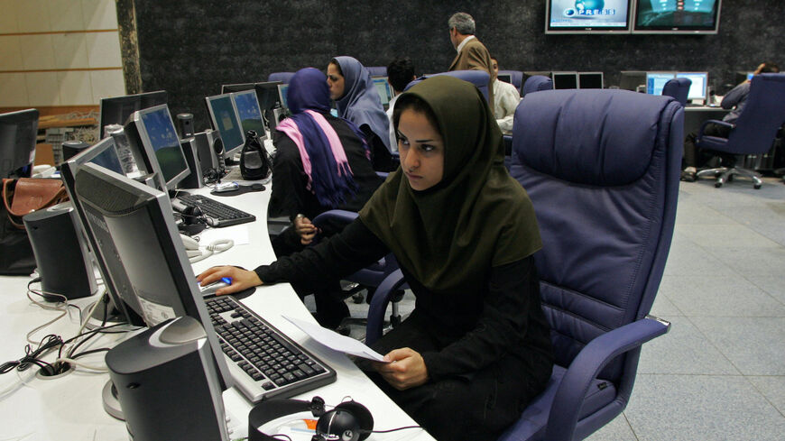 Tehran, IRAN: TO GO WITH AFP STORY BY FARHAD POULADI: Iranian staff members of "Press TV" news channel work at the newsroom in Tehran, 20 June 2007. An increasingly crowded market for 24-hour news is facing a new rival -- a channel from Iran whose self-proclaimed aim is to break the "stranglehold" of the West over the world?s media. Iran's state broadcaster is to launch "Press TV" on July 2 at a time of mounting international tension over its nuclear programme, complete with international journalists brough