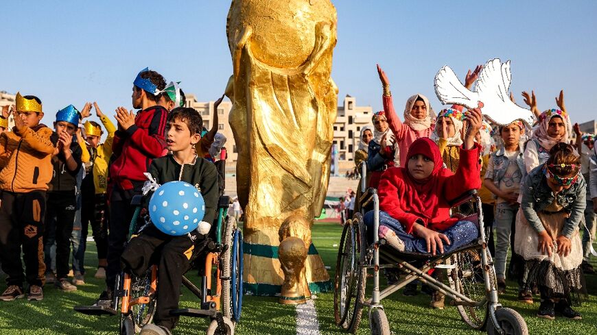 Syrian children take part in the opening ceremony of their own 'camps World Cup' tournament at the municipal stadium in Idlib