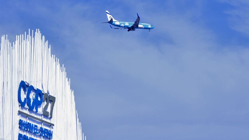 An airplane flies over the Sharm el-Sheikh International Convention Centre, during the COP27 climate conference in Egypt