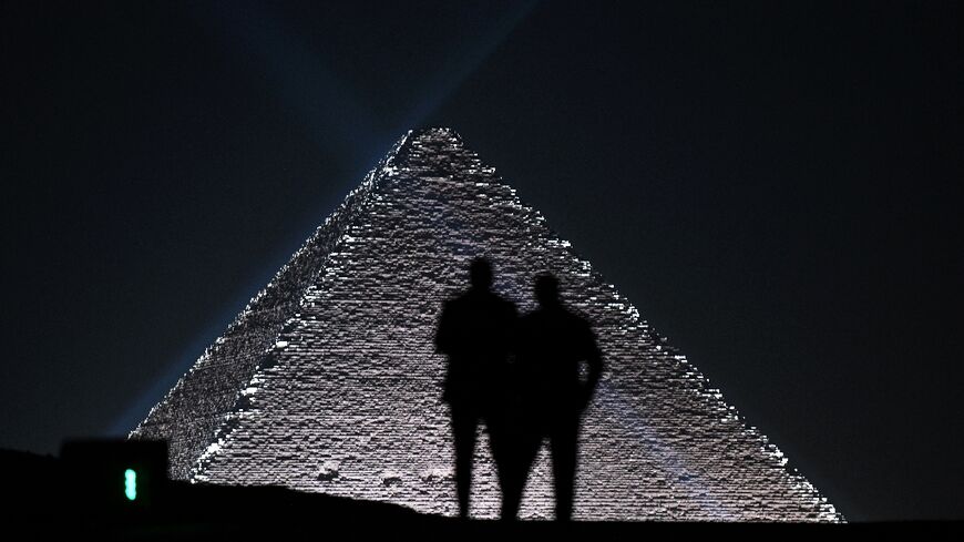 Models are seen against Egypt's Giza Pyramids at show by French fashion house Dior