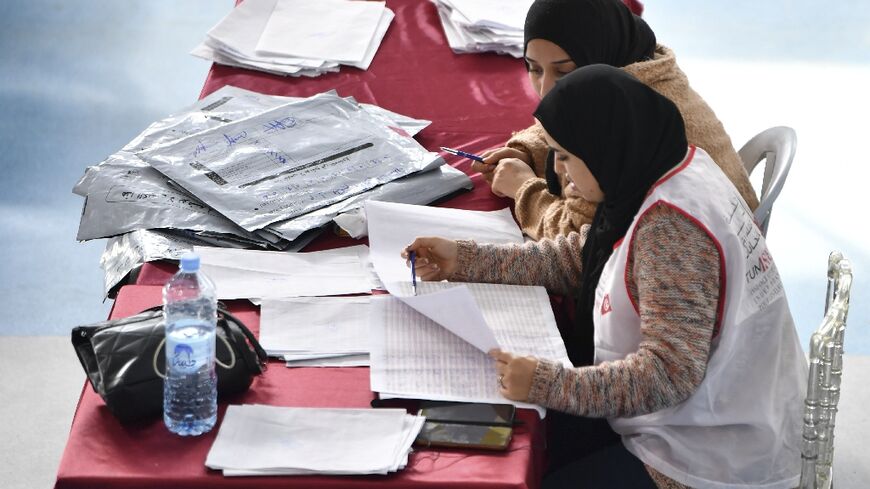 Members of the Tunisian electoral commission count votes on December 18, 2022 in Tunis, a day after voters overwhelmingly snubbed the elections for a neutered parliament 