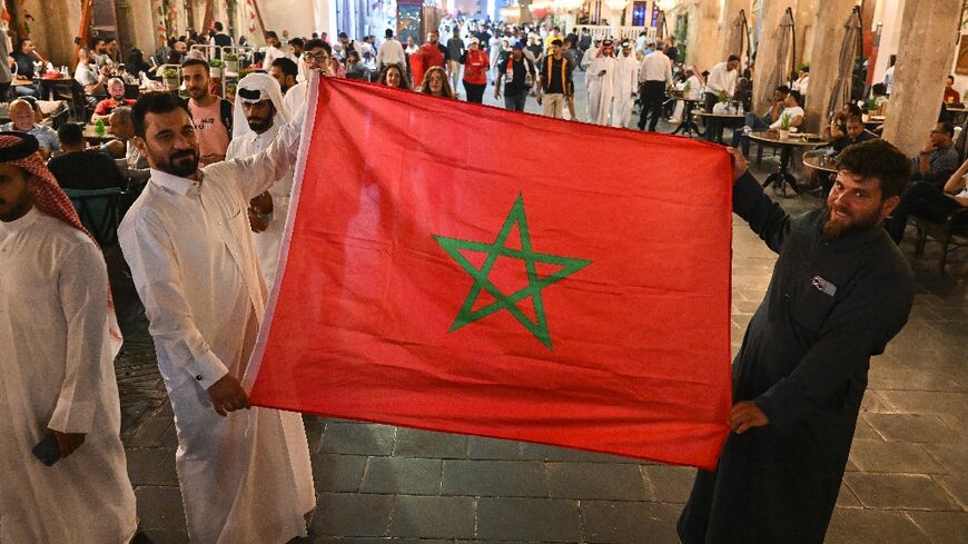 In Doha's Souq Waqif, Arab fans display Morocco's flag 