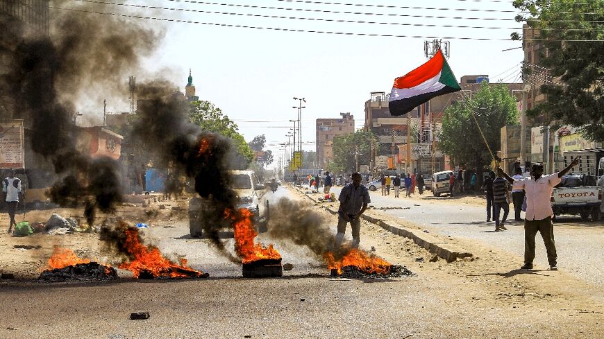 Sudanese protesters took to the streets Monday against a tentative deal aimed at ending the crisis provoked by last year's military coup