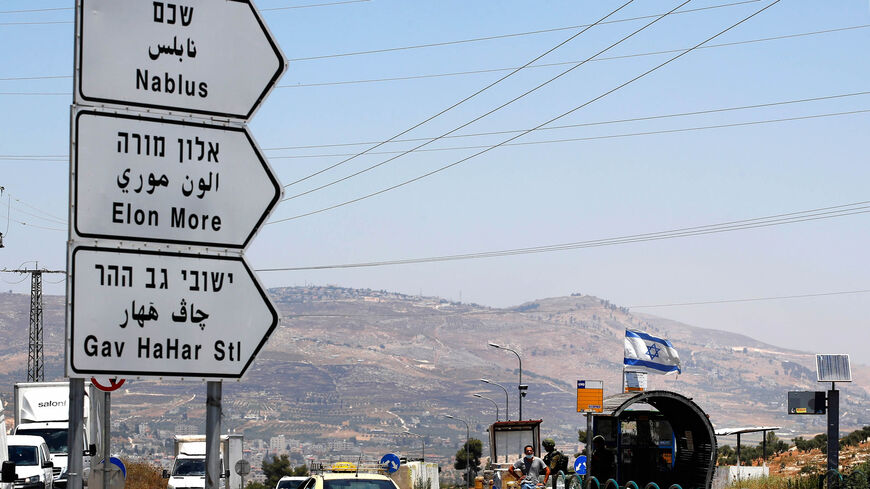 Israeli security forces guard a bus station at the Tapuach junction near the city of Nablus, West Bank, July 1, 2020.