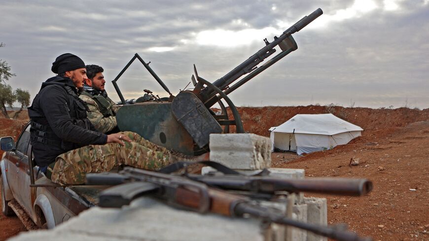 Fighters affiliated with the third corps of the Turkish-backed "Syrian National Army" man a turret at a position near Azaz in the rebel-held north of the Aleppo province, opposite the town of Menagh (Minaq) along the frontlines with areas under control by Syrian government forces and the Syrian Democratic Forces (SDF), on November 29, 2022.