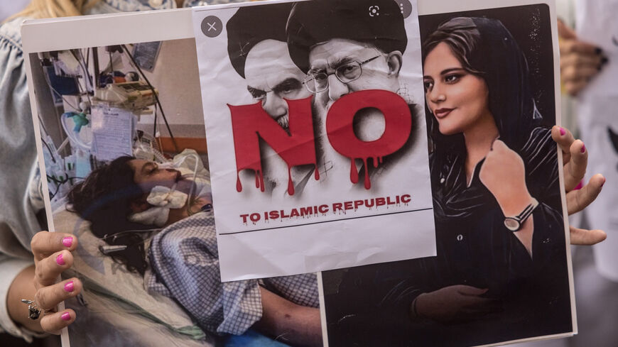 A woman holds a sign during a protest over the death of Iranian Mahsa Amini outside the Iranian Consulate on Oct. 7, 2022 in Istanbul, Turkey.