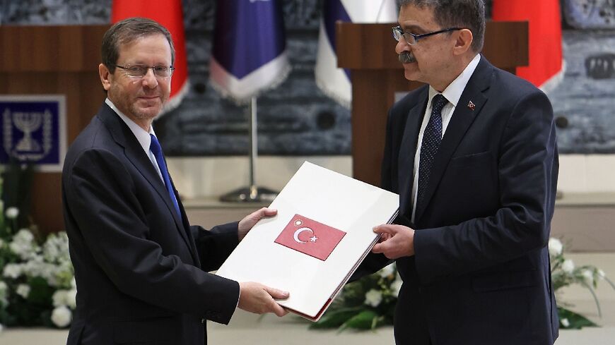 Turkey's ambassador to Israel Sakir Ozkan Torunlar (R), presents his credentials to Israeli President Isaac Herzog after Israel and Turkey announced in August the full restoration of relations and the return of ambassadors to both countries