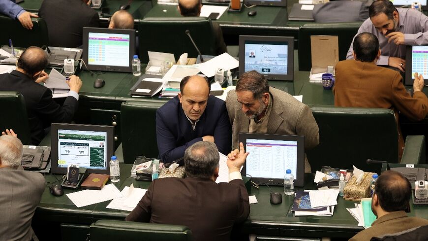 Iranian MPs attend the parliamentary session