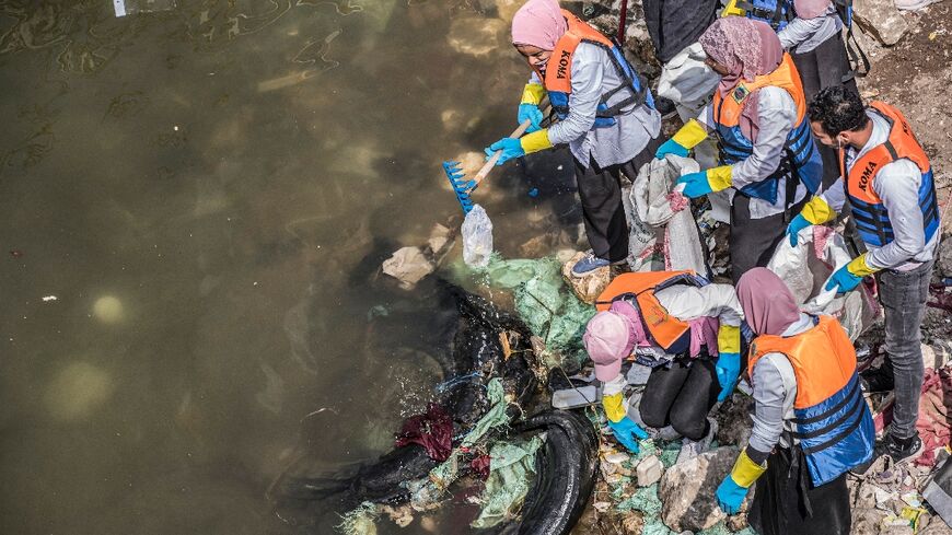 Volunteers collect garbage from the Nile in Egypt's capital Cairo in a clean-up campaign, on March 7, 2020