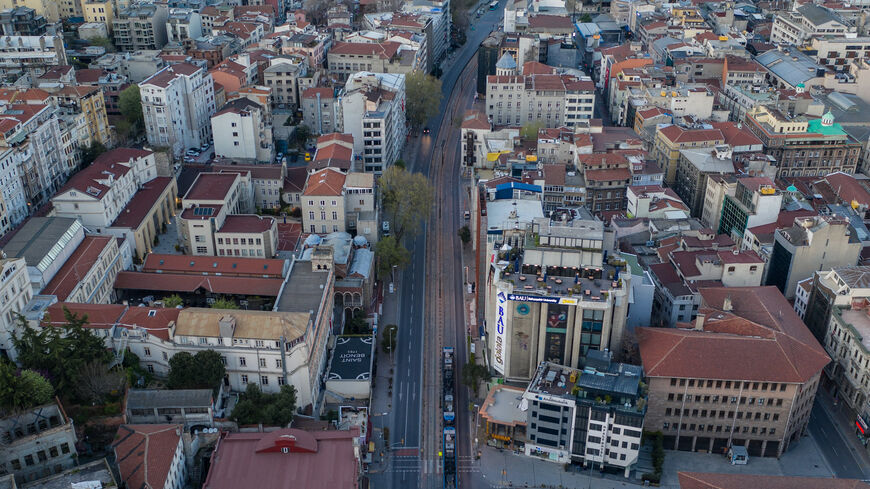 In this aerial photo from a drone, a tram passes an empty road in the Karakoy district on the final day of a four-day lockdown across Istanbul, Turkey, April 26, 2020.