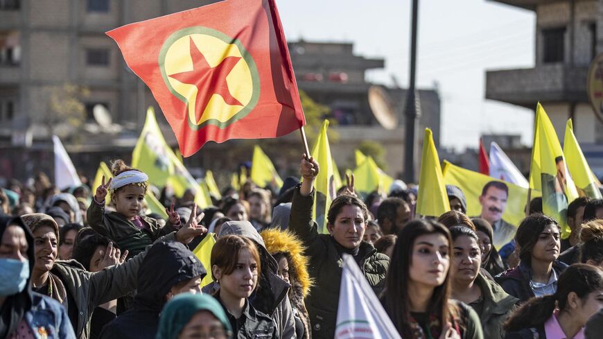 Protesters raise yellow flags showing the face of Abdullah Ocalan, the leader of the Kurdistan Worker's Party (PKK) -- currently prison in Turkey, and the red-star flag of the National Liberation Front of Kurdistan (ERNK - Eniya Rizgariya Netewa Kurdistan), during a demonstration calling for his release and condemning recent Turkish strikes on Kurdish areas, in the Kurdish-majority city of Qamishli in northeastern Syria on Dec. 6, 2022.