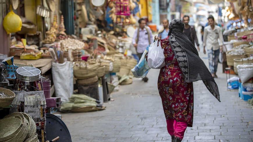 A Yemeni woman shops at a market in Yemen's third city of Taiz, on December 15, 2022. - Yemeni society, although deeply conservative, has traditionally allowed space for individual freedoms. But this is changing under the Huthi movement, which was founded with the aim of pushing for a theocracy. (Photo by AHMAD AL-BASHA/AFP via Getty Images)