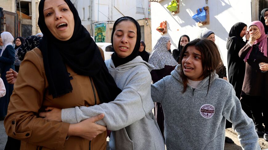 Relatives mourn during the funeral of Palestinians killed during an Israeli raid on the Jenin refugee camp in the occupied West Bank on January 26, 2023. - Israeli forces killed nine Palestinians, including an elderly woman, said officials in the occupied territory, while the Israeli military said troops traded fire with Islamist militants during a "counterterrorism operation". (Photo by ZAIN JAAFAR/AFP via Getty Images)