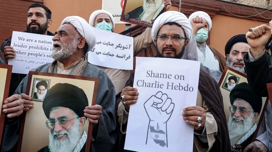 Demonstrators gather with images of Iran's supreme leader Ayatollah Ali Khamenei during a protest against weekly Charlie Hebdo outside the French embassy in Tehran