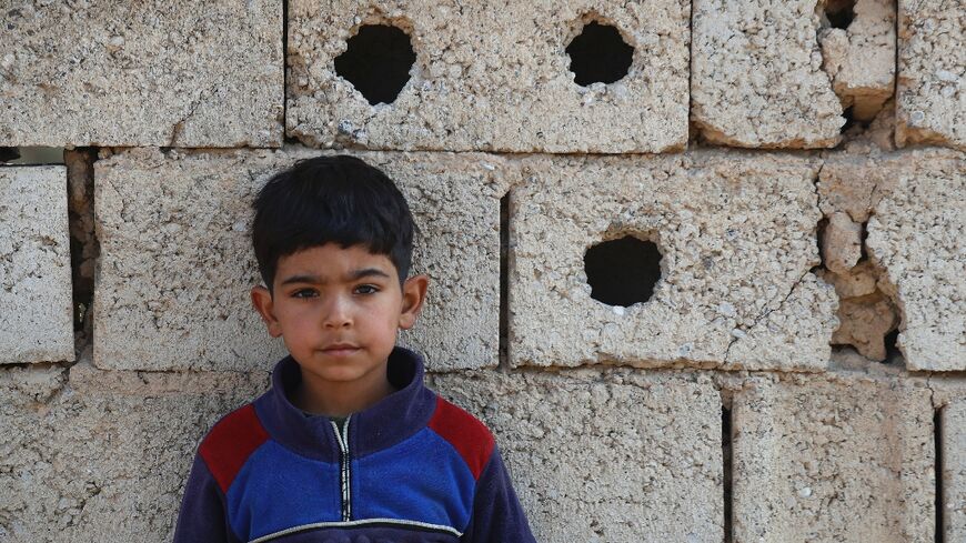 A young boy is pictured in the Iraqi village of Albu Bali where eight people were killed in an attack by Islamic State group jihadists last month