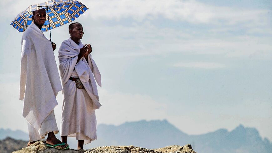 Muslim pilgrims pray on Mount Arafat, also known as Jabal al-Rahma (Mount of Mercy), southeast of the holy city of Mecca, during the climax of the Hajj pilgrimage, on July 8, 2022 