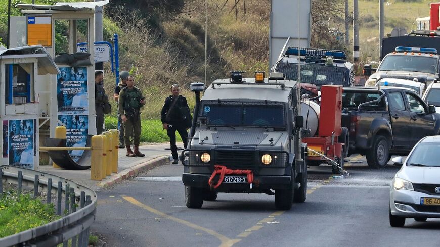 Israeli troops gather at the site outside a Jewish settlement in the occupied West Bank where the army says a Palestinian was killed as he attempted to stab a soldier