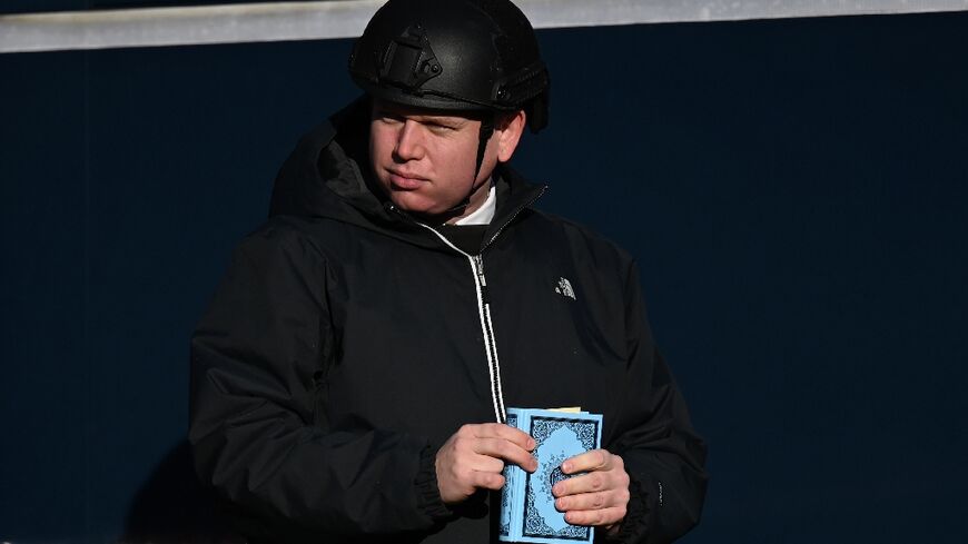 Far-right activist Rasmus Paludan holds a Koran before he burns it near a mosque in Copenhagen