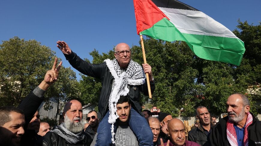 Arab Israeli Karim Younes is carried by friends and relatives following his release after 40 years in an Israeli prison for kidnapping and murdering an Israeli soldier, on January 5, 2023, in the norther Israeli town of Arara