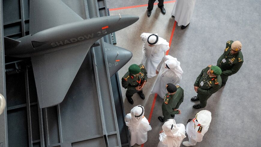 Visitors inspect the Halcon Shadow 25 "kamikaze" drones at the EDGE pavilion at IDEX in Abu Dhabi