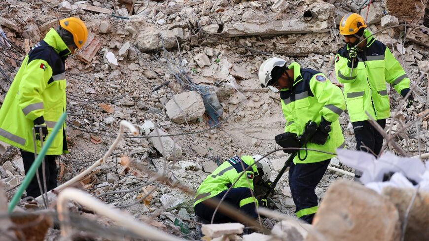 Emirati rescuers pursue search operations in the Syrian regime-controlled town of Jableh in Latakia province