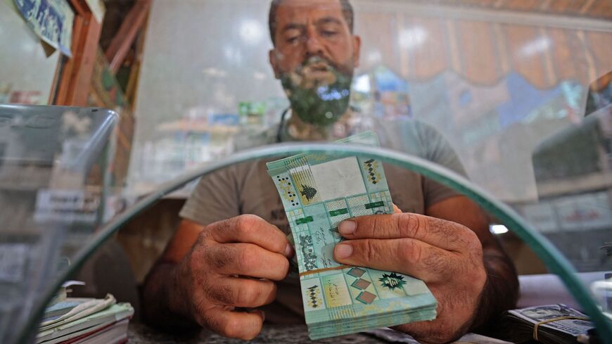 A money changer counts notes at his shop in the Lebanese capital, Beirut, on Sept. 22, 2022.
