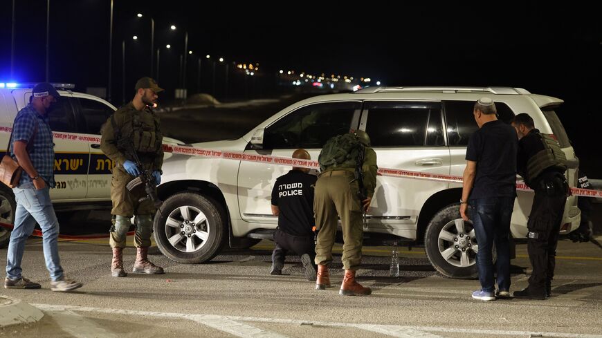 Israeli security forces examine the site of a reported shooting attack, near Jericho in the occupied West Bank on February 27, 2023. (Photo by AHMAD GHARABLI/AFP via Getty Images)