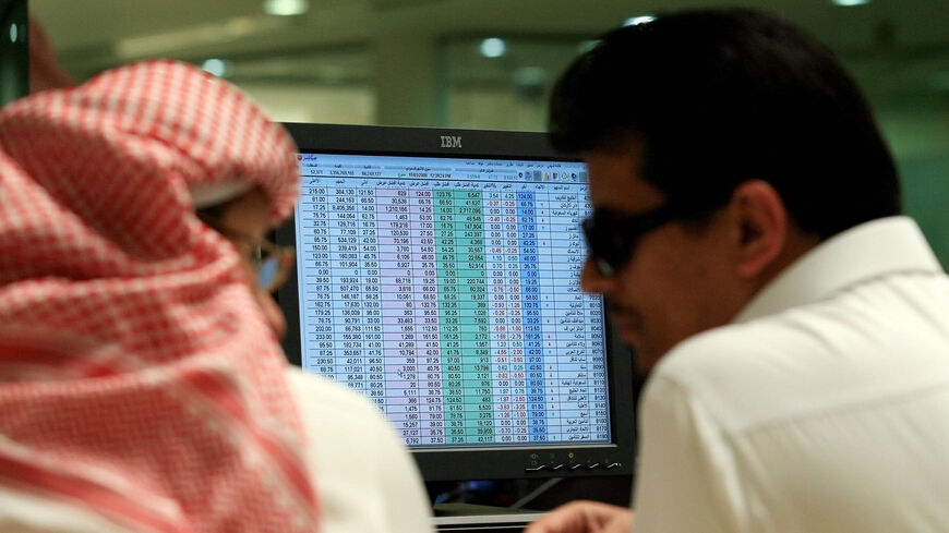 Saudi traders work at a bank in Riyadh on March 19, 2008. Asian stocks soared today after a big bounce on Wall Street as the US Federal Reserve slashed interest rates in a bid to contain a spiraling financial crisis and risk of recession. (Photo credit should read HASSAN AMMAR/AFP via Getty Images)