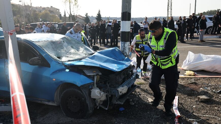 Israeli emergency responders gather at the site of a reported ramming attack in Jerusalem on February 10