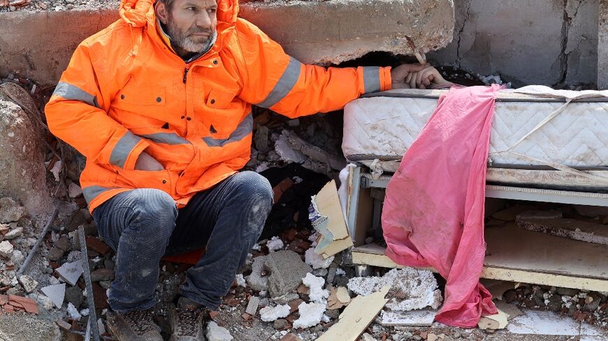 Mesut Hancer holds his dead daughter's hand. Irmak, 15, died in the Turkey-Syria quake