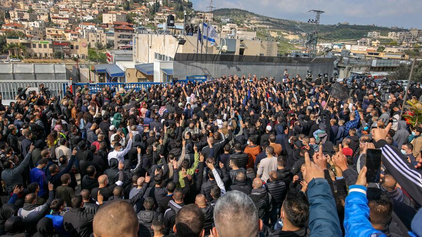 Israeli Arab men take part in a protest after a student was killed in a reported police shootout this week, in the northern Arab-Israeli town of Umm-Al Fahem on February 5, 2021. - Hundreds of Arab Israelis demonstrated protesters defied coronavirus restrictions on gatherings to demonstrate in front of the police station in the Arab-Israeli city of Umm al-Fahm. (Photo by AHMAD GHARABLI / AFP) (Photo by AHMAD GHARABLI/AFP via Getty Images)