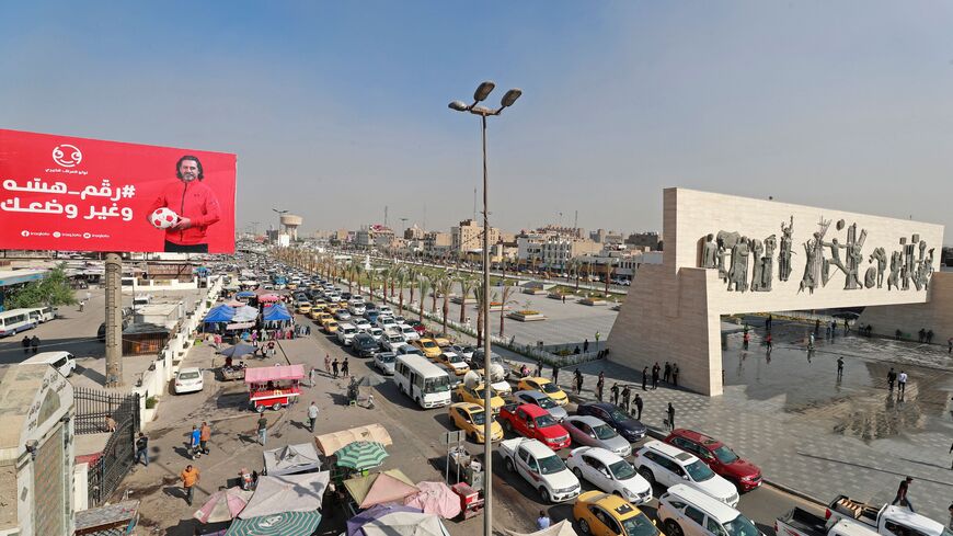 This picture shows traffic in Baghdad's Tahrir Square with the iconic Freedom Monument, a 50-metre (165-foot) long bas relief that honours the 1950 revolution which overthrew Iraq's monarchy, on November 7, 2022.(Photo by AHMAD AL-RUBAYE/AFP via Getty Images)