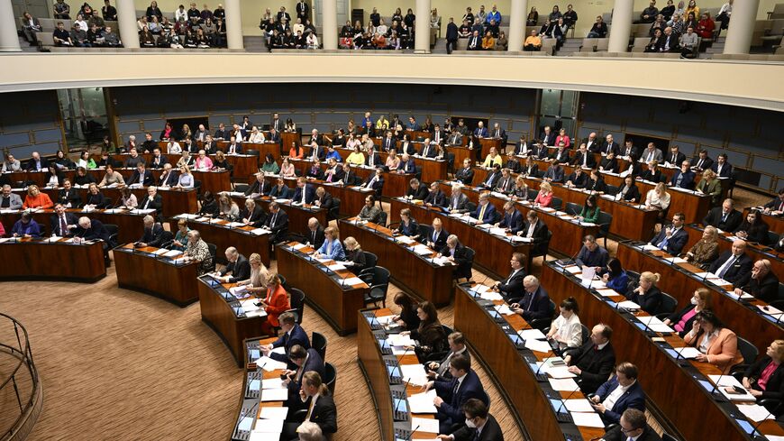 Finnish MPs attend a plenary session of the Finnish parliament on a vote on the country's entry to NATO in Helsinki, Finland on March 1, 2023. - Finland's parliament on March 1 voted overwhelmingly in favour of joining NATO, ahead of ratifications from Hungary and Turkey, increasing the likelihood it will enter the alliance before Nordic neighbour Sweden. Lawmakers approved a law affirming that Finland accepts the terms of the NATO treaty by 184 votes against seven. (Photo by Heikki Saukkomaa / Lehtikuva / 