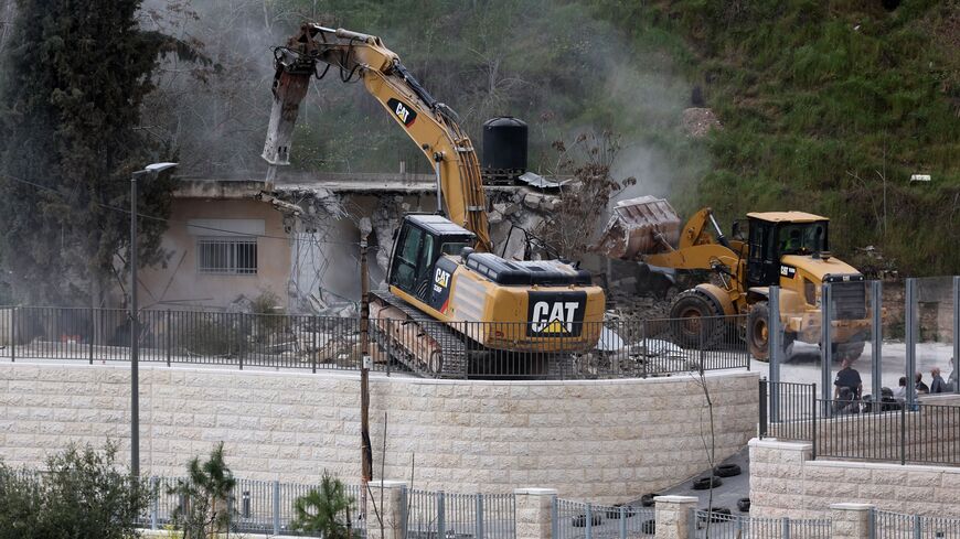 Israeli military bulldozers demolish a house of a Palestinian family, built without the municipality's permission, in the Jerusalem neighbourhood of Wadi al-Joz on March 6, 2023.  (Photo by AHMAD GHARABLI/AFP via Getty Images)