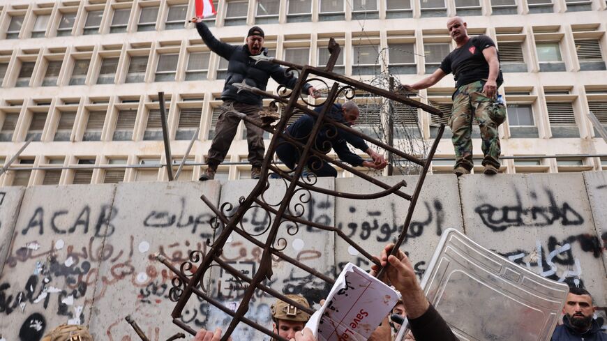 Retired servicemen clash with soldiers outside Lebanon's central bank during a demonstration demanding inflation-adjustments to their pensions, in Beirut on March 30, 2023. (Photo by JOSEPH EID / AFP) (Photo by JOSEPH EID/AFP via Getty Images)