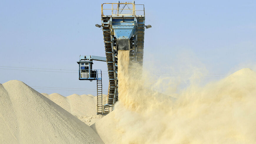 This picture taken on May 13, 2013 shows untreated phosphate being dropped off on a montain at the end of a conveyor belt at the Marca factory of the National Moroccan phosphates company (OCP/public), near Laayoune, the capital of Moroccan-controlled Western Sahara. - As a global leader in the market for phosphate and its derivatives, OCP has been a key player in the international market since its founding in 1920, the worlds largest exporter of phosphate rock and phosphoric acid and one of the worlds large