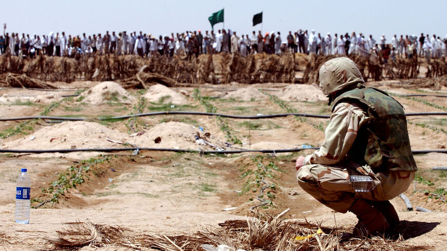 Shiite Muslims protest near the local headquarters of the US-led Coalition Provisional Authority on July 20, 2003, in Najaf, Iraq.