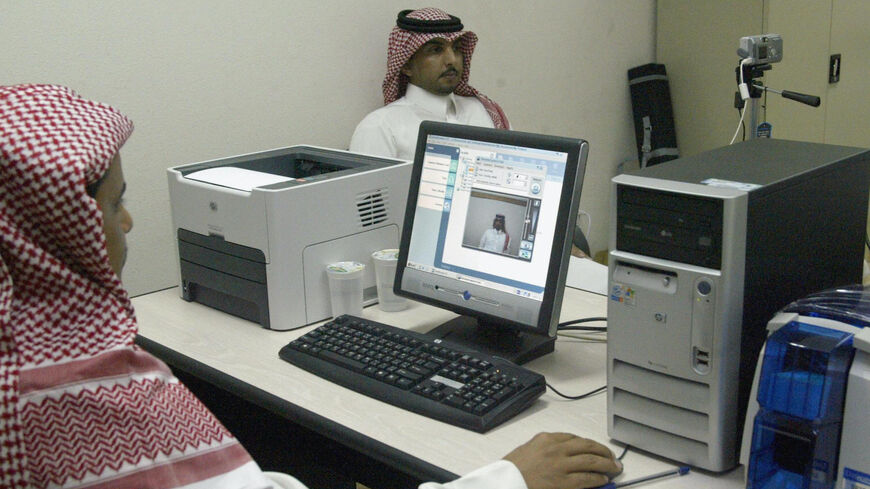  A Saudi man has his picture taken for his election ID card as registration opened 23 November 2004, for the kingdom's first municipal elections, to be held in February 2005. The first round of the elections, in which women are barred from voting, is the first of the three-stage process of choosing half the members of 178 municipal councils, the other half of which are named by the government, in a drive to introduce limited reforms which Riyadh insists must be tailored to Saudi specifications and not neces