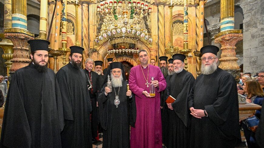 The Patriarch of Jerusalem Theophilos III (C) holds a flask containing the holy chrism oil which will be used to anoint Britain's King Charles III during his coronation