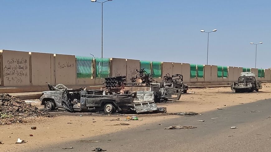 Destroyed vehicles beside a road in southern Khartoum