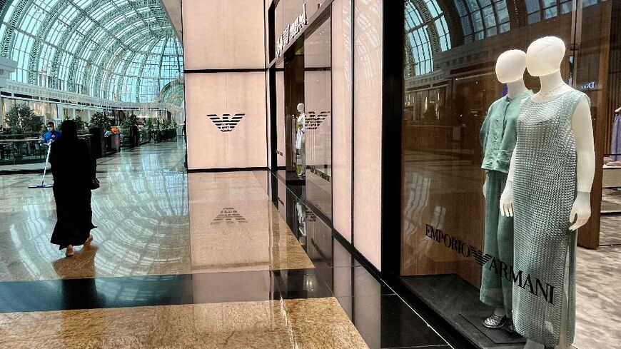 A woman walks past an Armani shop in the Mall of the Emirates in Dubai