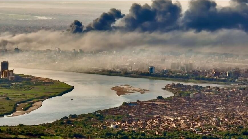 Black smoke covers the sky above the capital Khartoum