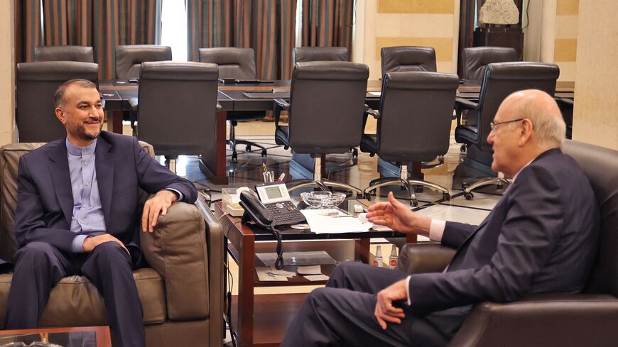 Lebanon Prime Minister Najib Mikati (R) and Iran's Foreign Minister Hossein Amir-Abdollahian meet in Beirut on October 7, 2021. (Photo by anwar amro / AFP) (Photo by ANWAR AMRO/AFP via Getty Images)