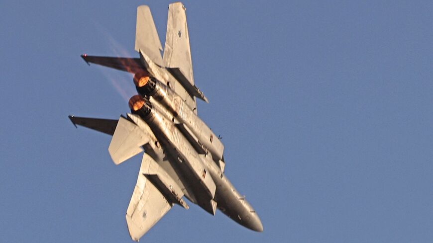 A F-15 fighter jet takes part in an aerial display during the graduation ceremony of Israeli air force pilots at the Hatzerim base in the Negev desert, on June 23, 2022. 